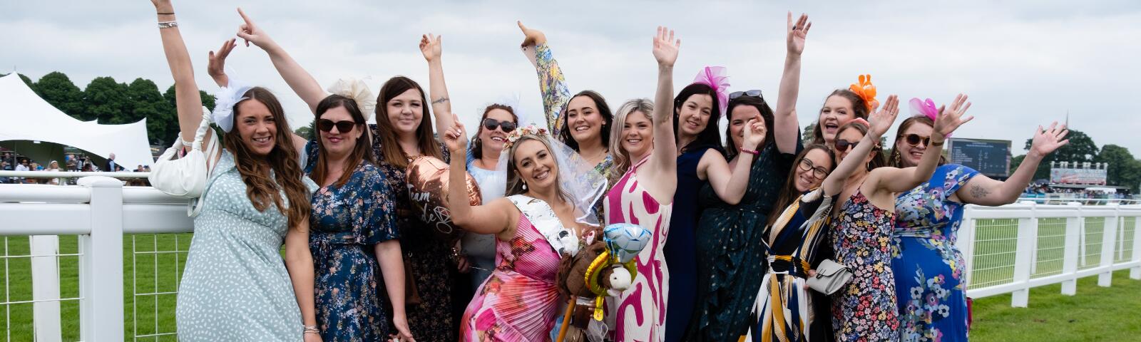 A large hen party poses at the trackside at Worcester Races
