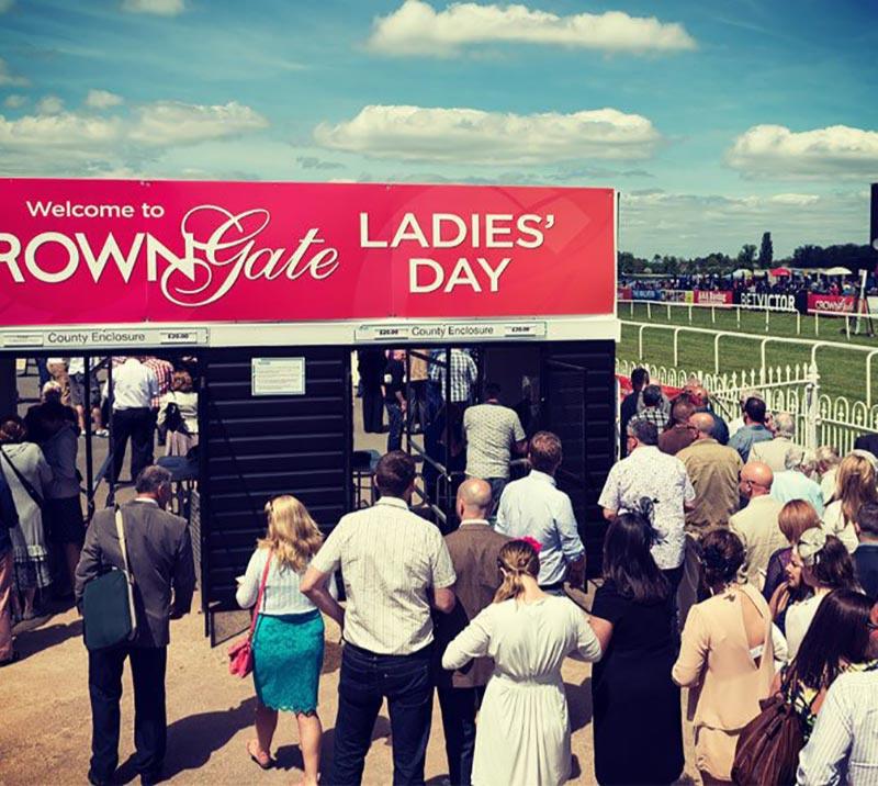 Crowds lining up to enter the Worcester Racecourse grounds.