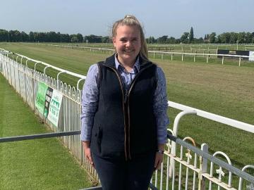 A young lady poses for the camera at Worcester Racecourse